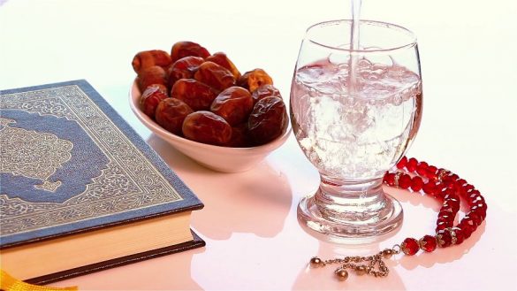 videoblocks table with holy quraan dates rosary and some one pouring water into a glass ready for happy breakfast in ramadan h49f frag thumbnail full06 07 43 524428